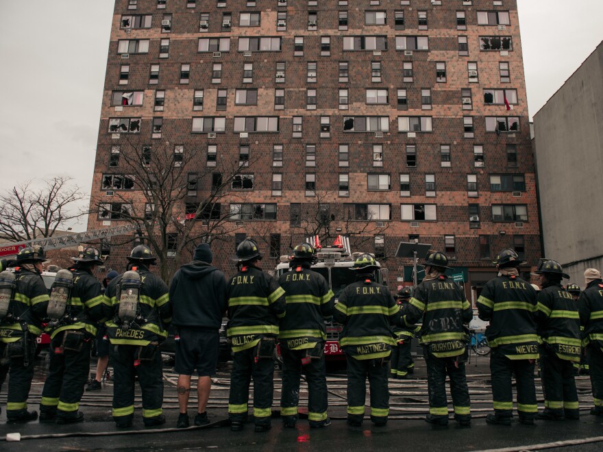 Emergency first responders remain at the scene after an intense fire at a 19-story residential building that erupted on Sunday in the Bronx, New York City.