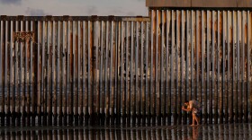 A man takes an image with his phone next to where the border wall separating Mexico and the United States reaches the Pacific Ocean Jan. 28, 2025, in Tijuana, Mexico.
