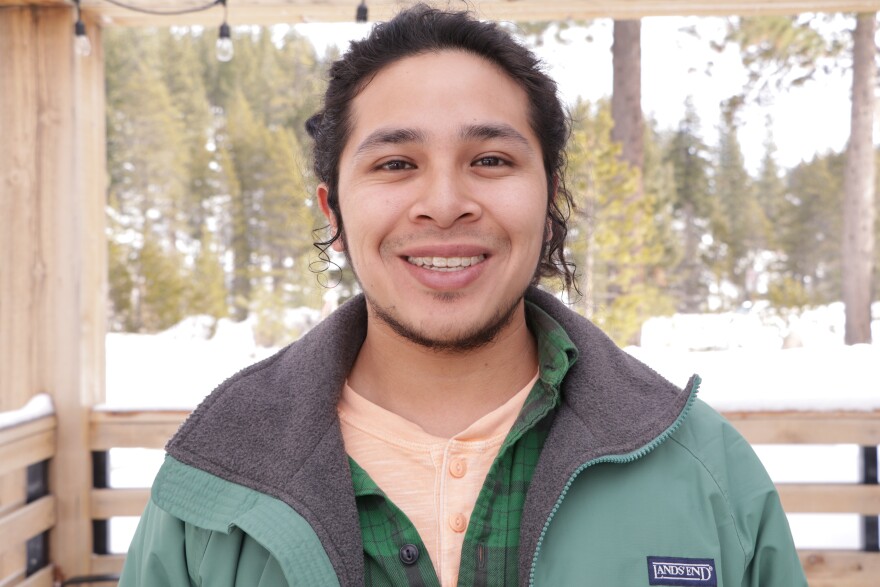 Man smiles in front of camera.