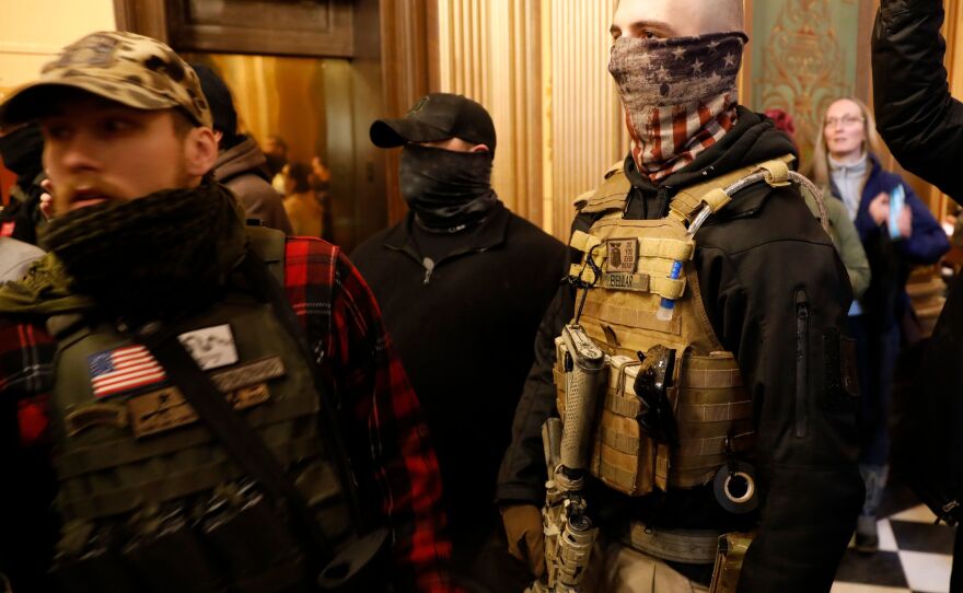 Protesters try to enter the chamber and are being kept out by police during a protest in Lansing, Mich., on Thursday.