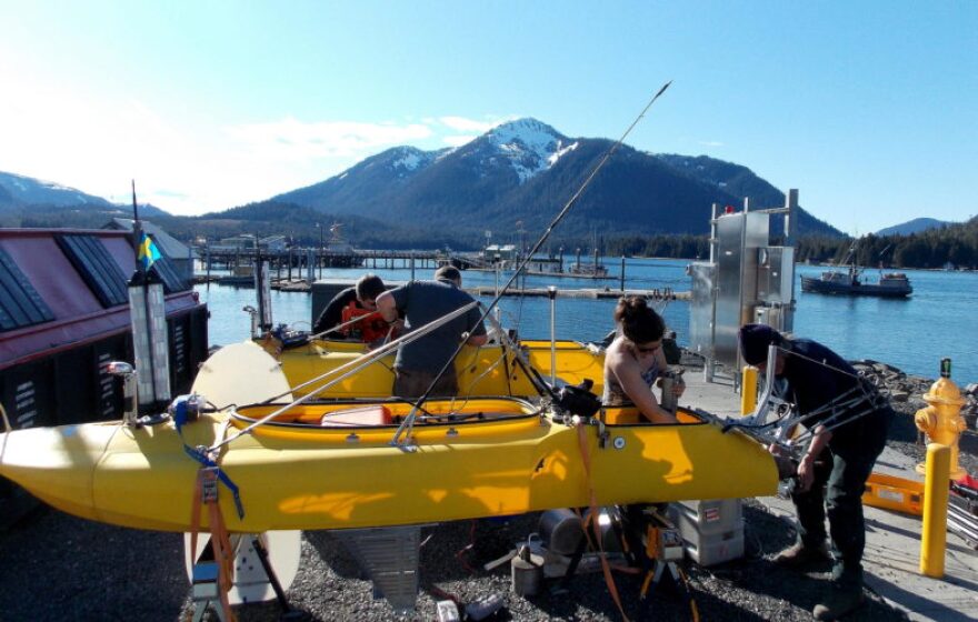 Mechanical engineer, June Marion, works on the kayak’s engine assisted by her dad, Bobby Brown. Working on the rear kayak is robotics science students, Nick McComb and Corwin Perren. (Photo/Angela Denning)