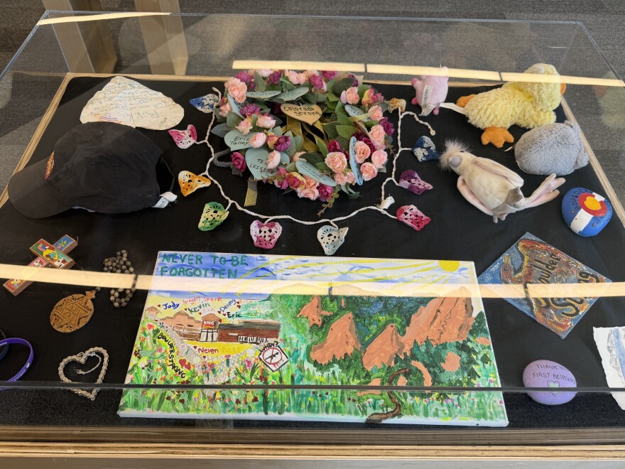 Items recovered from the makeshift memorial that sprang up outside the Boulder King Soopers following the 2021 shooting are displayed at the Museum of Boulder on Sunday, March 22, 2026. The Day of Remembrance for the shooting was held alongside the items and portraits of the shooting's victims.