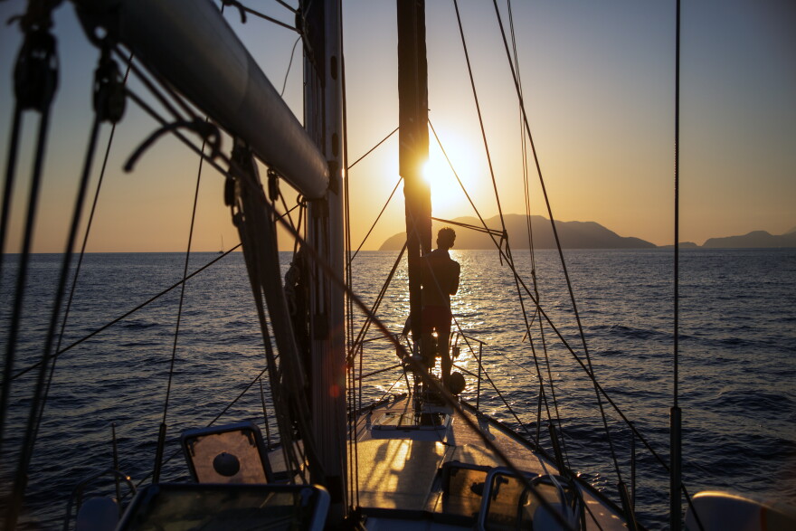 Sailing the Aeolian Islands at sunset Sicily, Italy.