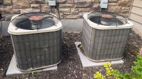 Two air conditioning units sit outside of a Lehi apartment complex, July 3, 2023.