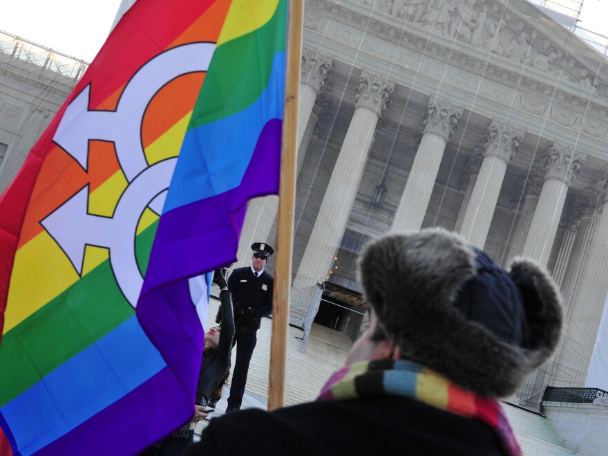 A pro-gay-marriage protester stands in front of the Supreme Court on Tuesday, the first of two days of oral arguments on challenges to laws that limit the definition of marriage to unions of a man and a woman.<strong></strong>