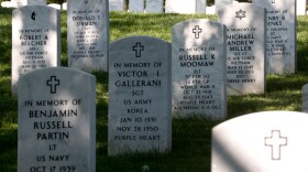 FILE - Rows of gravestones stand at the Arlington National Cemetery in Arlington, Va., May 13, 2014.