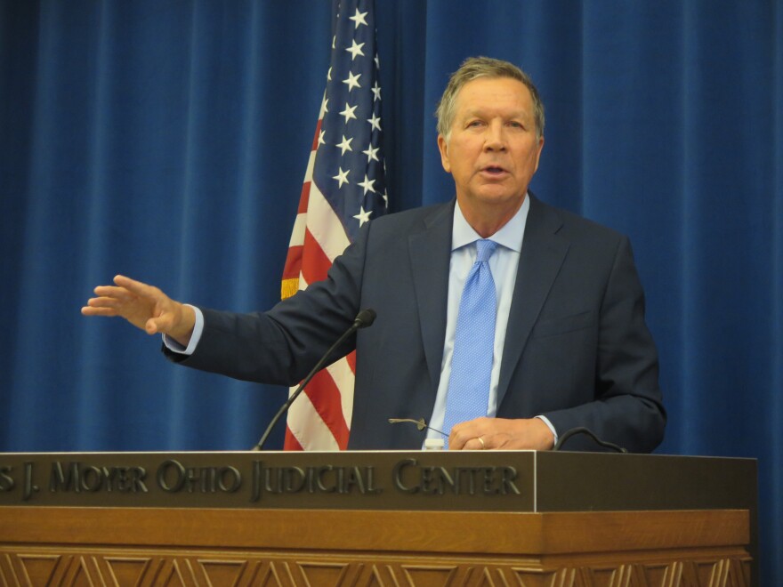 Governor John Kasich gestures at podium