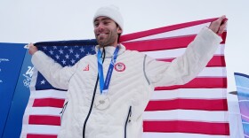 Silver medalist United States' Alex Hall holds an American flag after the men's freestyle skiing slopestyle finals at the 2026 Winter Olympics, in Livigno, Italy, Tuesday, Feb. 10, 2026.