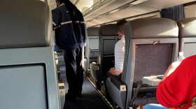 A conductor collects tickets on Amtrak's Cardinal Line between Chicago. and Indianapolis
