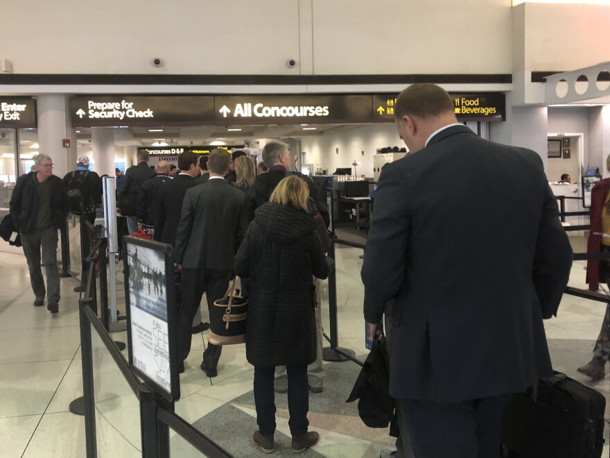 Passengers wait in line at a T.S.A. Security Checkpoint at Charlotte Douglas International Airport a week before holiday travel season begins.