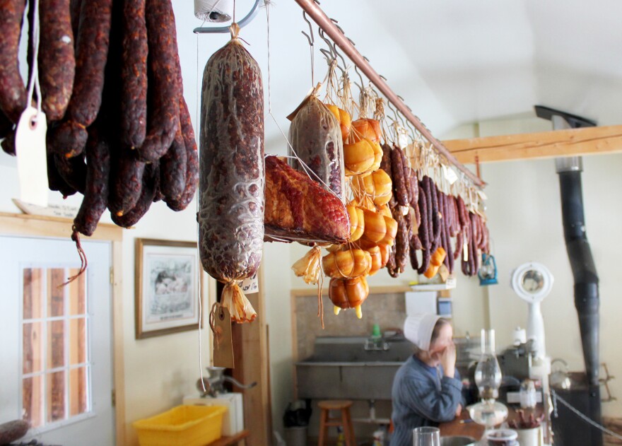 Matthew Secich's wife, Crystal, behind the sausage counter at the deli they opened in Unity, Maine.