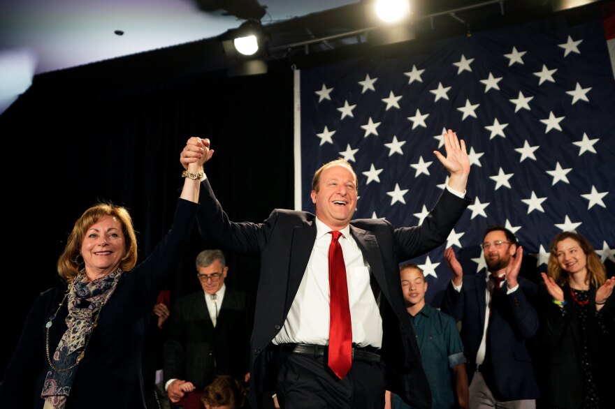 Jared Polis arrives onstage with running mate Dianne Primavera in Colorado. Polis defeated Walker Stapleton to become the first openly gay man elected governor in the U.S.