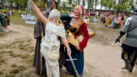 The Patton family from Cleveland dressed as album artwork. Shawn Patton (left) is the Hermit from "Led Zepplin IV", Amanda Patton (right) is dressed as the cover of Smashing Pumpkins' "Mellon Collie and the Infinite Sadness" and their 13-year-old daughter (center) is dressed as Lady Justice from Metallica's "...And Justice for All."