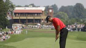 Tiger Woods taps in his par putt on the first hole during the final round of the Bridgestone Invitational golf tournament at Firestone Country Club in Akron, Ohio, Sunday, Aug. 7, 2011. 