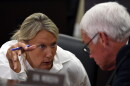 Senate Majority Caucus Chair Julie Raque Adams, a Louisville Republican, confers with Sen. Stephen Meredith about the implementation of Senate Bill 151 during an Interim Joint Committee on Families and Children meeting.