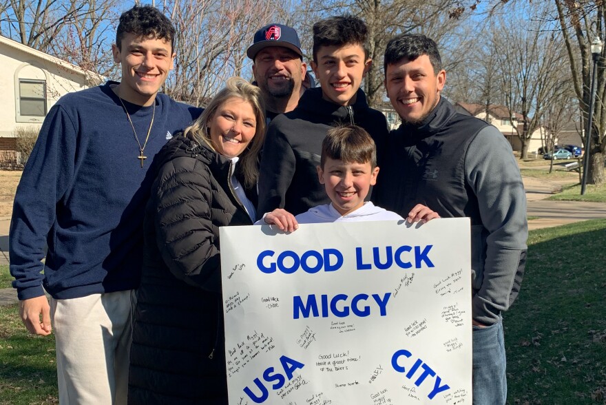 The Perez family poses with Miguel [center, top] on the day he left for Argentina to join the United States U-19 Men’s National Team. The poster was made by his cousins.