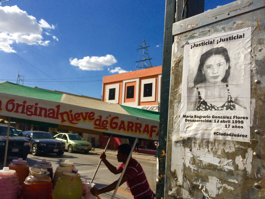 A missing woman's flyer on a wall while a vendor walks past