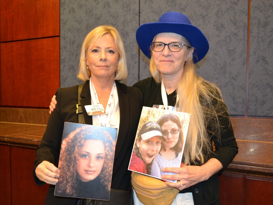 Lois Durso (left) holds a picture of her daughter, Roya. Marianne Karth (right) holds a picture of her daughters, AnnaLeah and Mary.