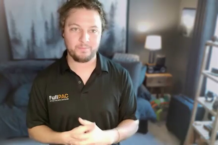 A man wearing a black polo shirt with FullPAC written on it