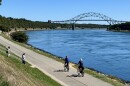 Cyclists ride the Canal Service Road, also called the bike path, on the north side of the Cape Cod Canal, heading toward the Sagamore Bridge, September 15, 2022.