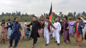 Youth dance as they celebrate the reduction in violence, in Jalalabad. 