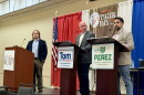 Tallahassee City Commission Seat 3 candidates Tom Derzypolski (center) and PJ Perez (right) participating in a Capitol City Tiger Bay debate moderated by WFSU Public Media reporter Tristan Wood (left) on Sept. 29, 2026.