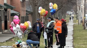  People visit a makeshift memorial for 11-year-old Brexialee Torres-Ortiz, who was shot and killed Monday night on Oakwood Ave. In Syracuse