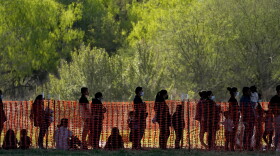 In this March 19, 2021, file photo, migrants are seen in custody at a U.S. Customs and Border Protection processing area under the Anzalduas International Bridge, in Mission, Texas. U.S. authorities say they picked up nearly 19,000 children traveling alone across the Mexican border in March. It's the largest monthly number ever recorded and a major test for President Joe Biden as he reverses many of his predecessor's hardline immigration tactics.