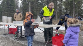 Students receive trout to stock Johnson Lake at the 22nd annual Salmon Celebration.