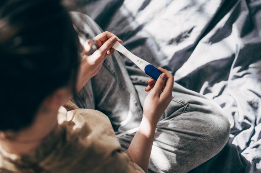A woman takes a pregnancy test at home. (Viktoriya Skorikova/Getty Images)