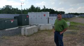 Kevin Sullivan in front of the solar array on his property.