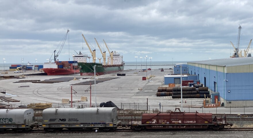 A view of the Port of Cleveland, looking past rail cars to ships docked  in the distance.