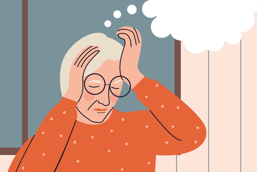 A woman holds her head with an empty thought bubble hovering above her