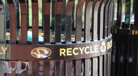 A close up of an MU campus waste can that has the MU tiger logo and the word "Recycle."