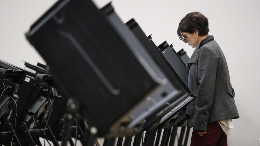 A voter casts her vote early at the Franklin County Board of Elections in Columbus, Ohio, on Wednesday.