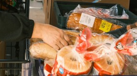 A shopper picks out bagels at River City Food Bank. Oct. 30, 2025