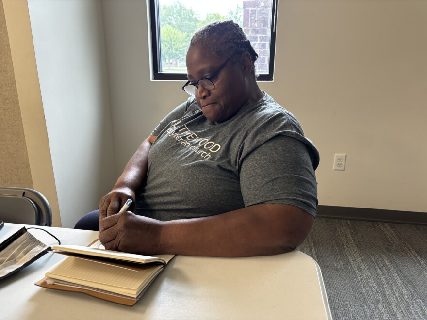 Audrey Carma, founder of Wanna Buddy Ministry in Columbia, writes in her journal before an interview.