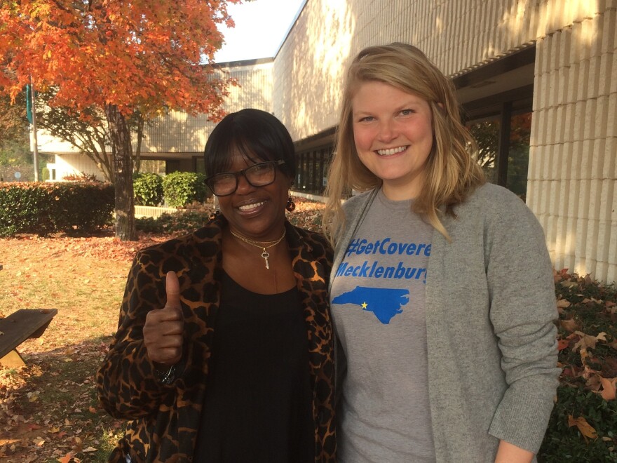 Darlene Hawes (left) and her enrollment counselor, Julieanne Taylor, outside the Mecklenburg County Health Department in Charlotte, N.C.