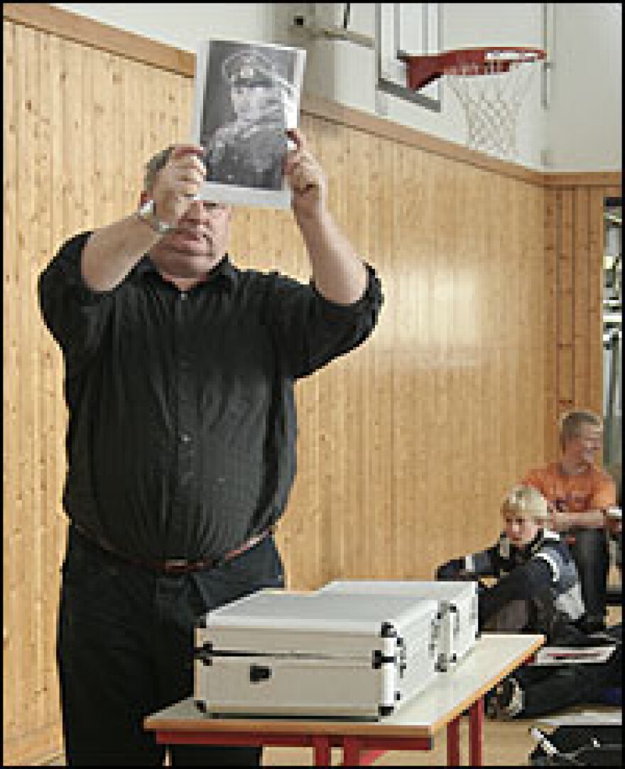 Trying to de-romanticize World War II, Michael Ankele shows students a picture of a German soldier from that time. He also read part of the soldier's letter home, which spells out his miserable experience in the war.