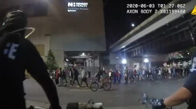 A screenshot of a body camera video from a CMPD officer shortly after one discusses a plan to tear gas protesters.