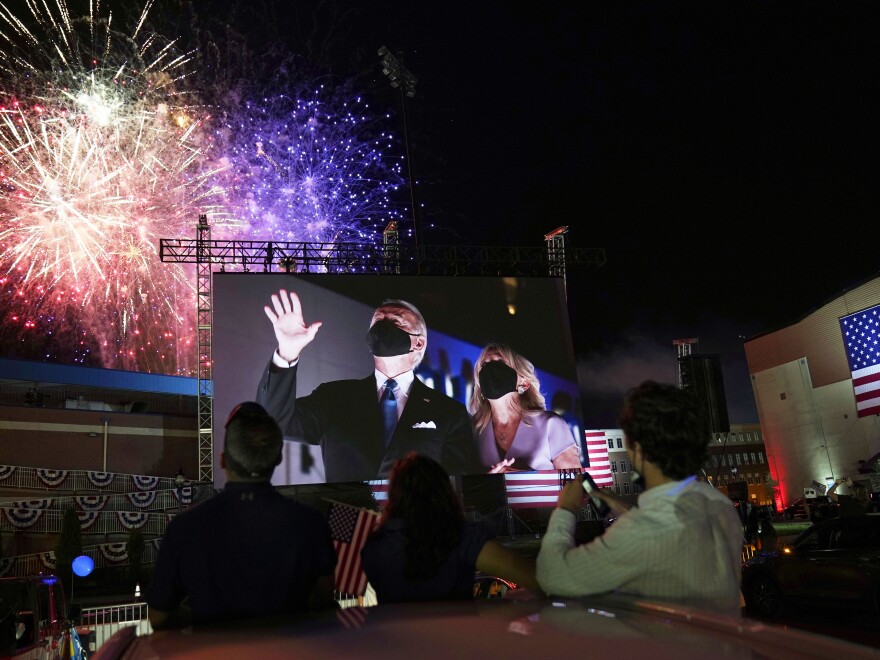 Democratic presidential candidate former Vice President Joe Biden, and his wife Jill Biden, are shown on large screens outside the Wilmington, Del., venue where Biden spoke on the final day of the Democratic National Convention.