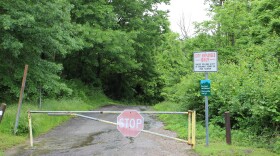 A locked gate blocks traffic from the site of the work camp that was the base for the creation of Mt. Airy Forest.