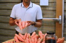 Resham Thapa, an associate research professional in the Center for Carbon Capture and Conversion at the University of Wyoming School of Energy Resources, holds up some of the carrots grown with coal char in the soil.