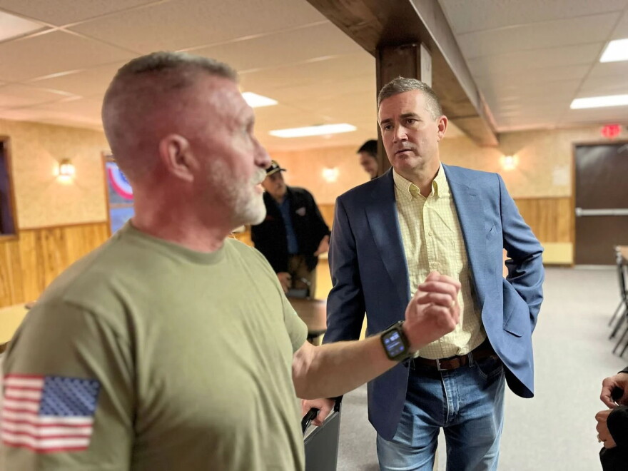 Blake Gendebien, right, speaking with Joe Fisher, an independent voter who attended Gendebien's recent event at the VFW in Saranac Lake, New York.