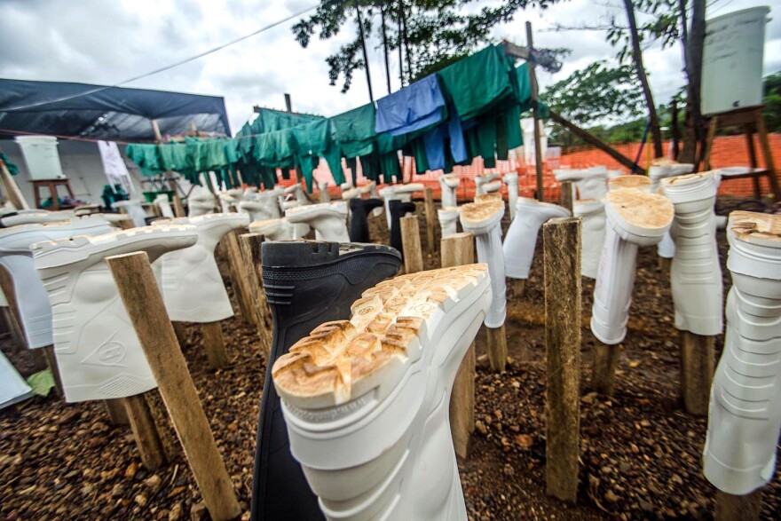 Wellington boots, part of health workers' protective gear, hang out to dry at the Doctors Without Borders' treatment center in Kailahun, Sierra Leone. Dr. Khan is now an Ebola patient in the center's isolation ward.