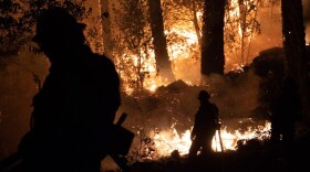 Firefighters defend a home along CA-29 near Robert Louis Stevenson State Park outside Calistoga, CA, Thursday. Oct. 1, 2020.