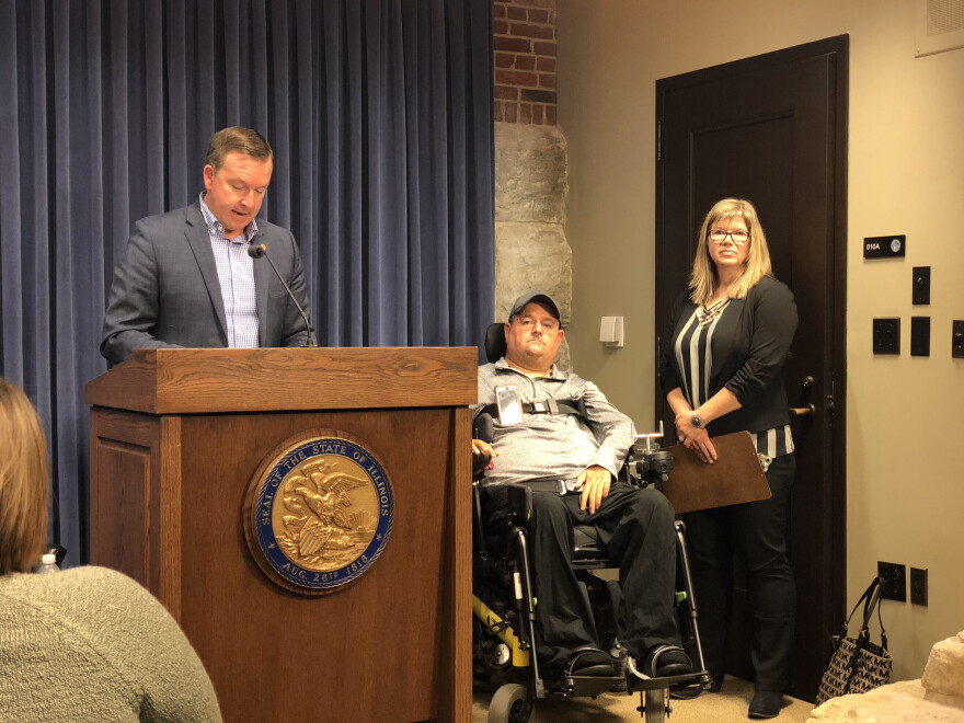 State Sen. Andy Manar (left) with David Spurney (middle) and his caregiver Tami Straub (right) at a press conference about the overtime cap for personal assistants. 
