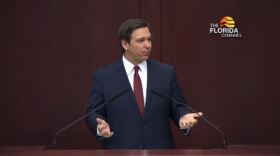 Man speaks at podium