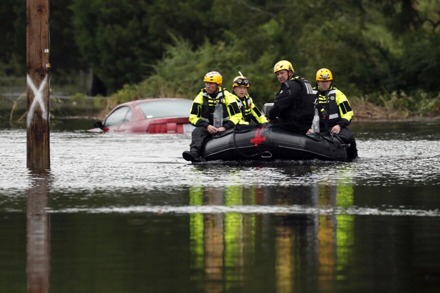 Members of a swift water rescue team check a flooded street caused by the tropical storm Florence in New Bern, N.C., on Saturday. Rescuers have pulled more than 200 people from their homes to safer ground as of Saturday morning in New Bern.