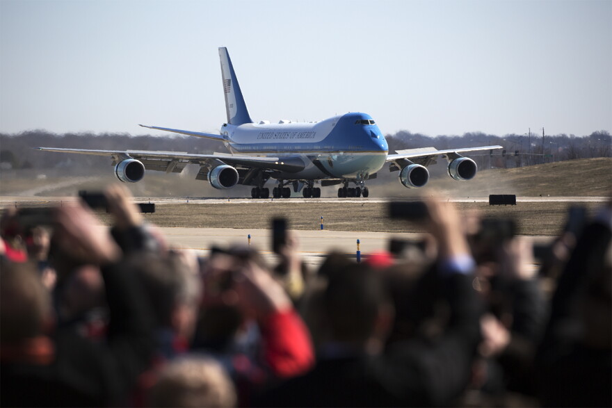 Onlookers watch as Air Force One lands at St. Louis Lambert International Airport in March 2018.
